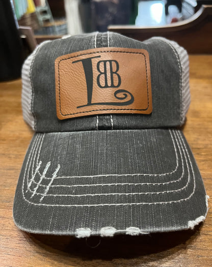 Little Black Book: Women in Business Distressed Trucker Hat with Leather Patch